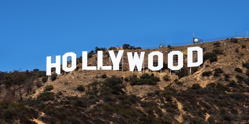 The Hollywood Sign on a hillside under a clear blue sky