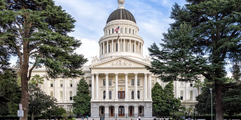 California State Capitol building with trees and lawn in daytime